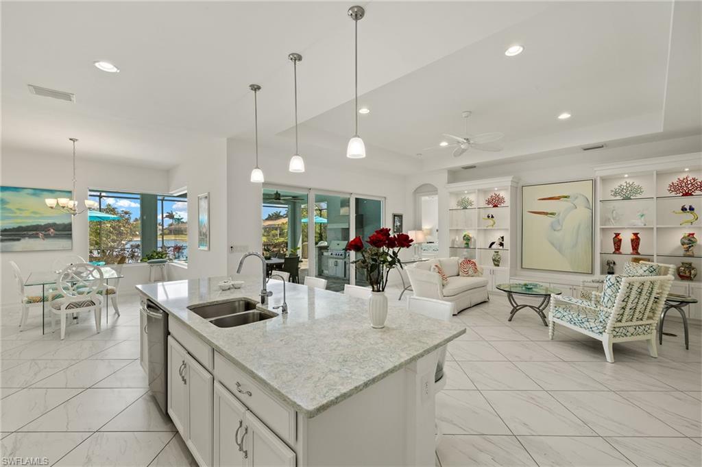 14809 Windward Lane Naples, FL 34114 - Photo 50 of 50 a kitchen with counter space dining table and chairs