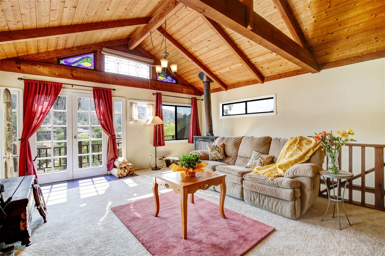 8670 Almond Road Lakeside, CA 92040 - Photo 8 of 22 Cozy relaxing living room. Rustic Knotty Pine Open Beam Ceiling. Pretty leaded glass windows to gaze through to the outstanding mountain views.