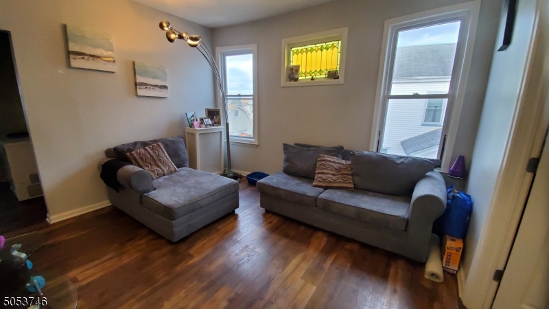 34 Olive Street, Unit 2 Bloomfield, NJ 07003 - Photo 2 of 19 a living room with furniture and a wooden floor