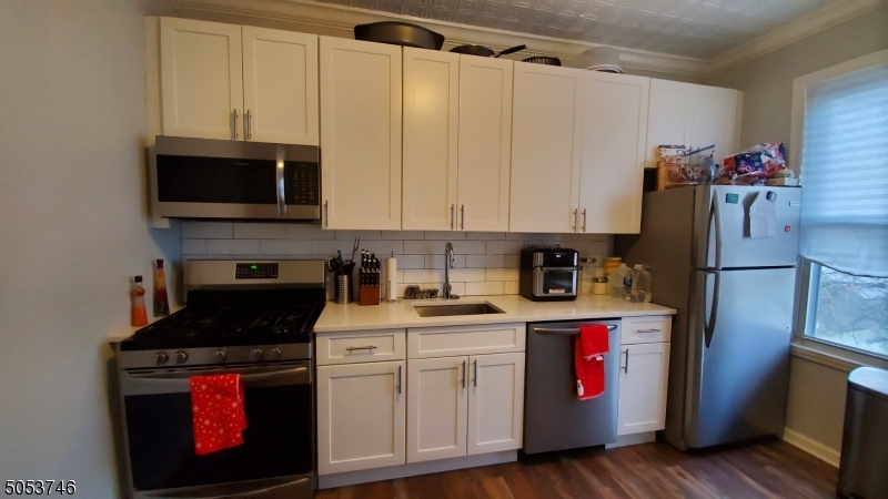 34 Olive Street, Unit 2 Bloomfield, NJ 07003 - Photo 12 of 19 a kitchen with stainless steel appliances granite countertop a refrigerator stove and sink