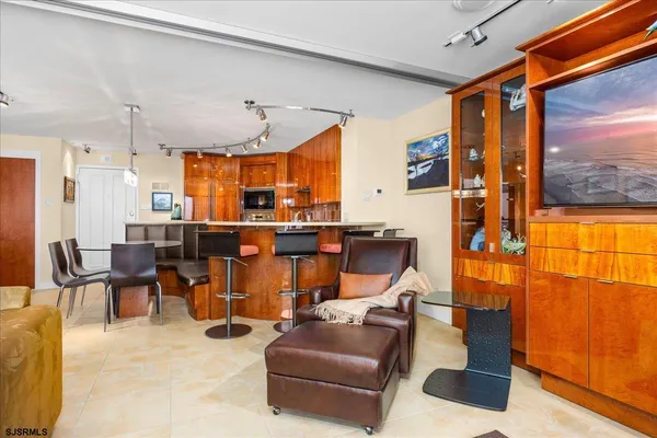 a living room with furniture a floor to ceiling window and outdoor view