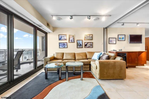 a living room with furniture and a floor to ceiling window