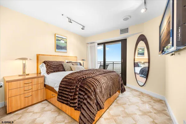 a bedroom with a bed and a large window