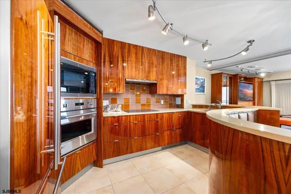 a kitchen with stainless steel appliances granite countertop a sink and cabinets