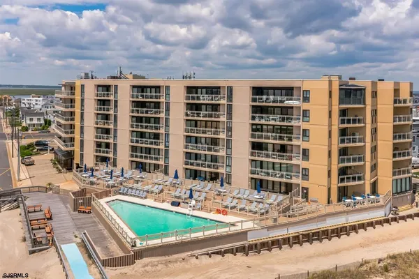a view of building with a swimming pool and outdoor seating