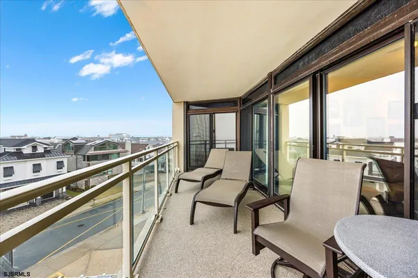 a balcony with furniture and view of city