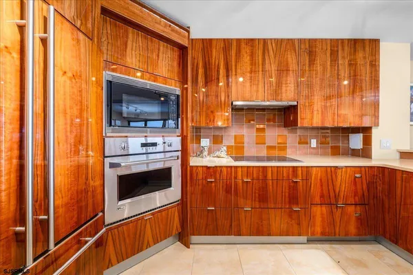 a view of a kitchen with an oven and wooden cabinets