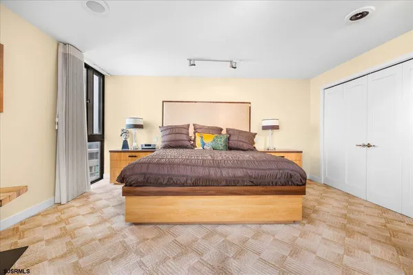 a bedroom with a large bed and a window
