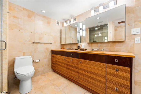 a bathroom with a sink a toilet and mirror