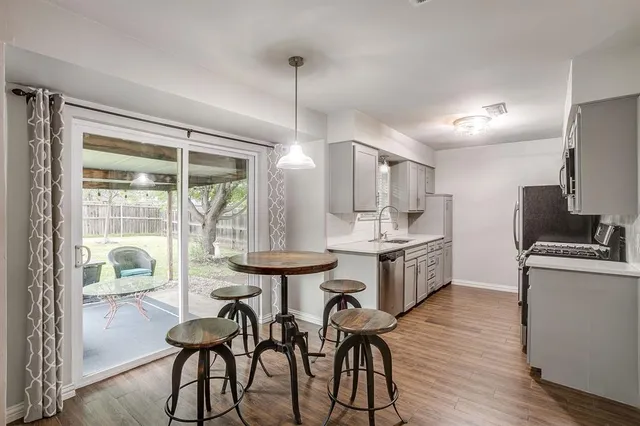 a kitchen with sink cabinets and wooden floor