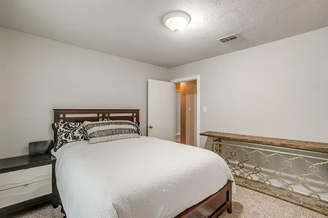 a bed sitting in a bedroom and table