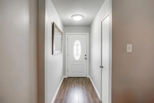 a view of a hallway with wooden floor