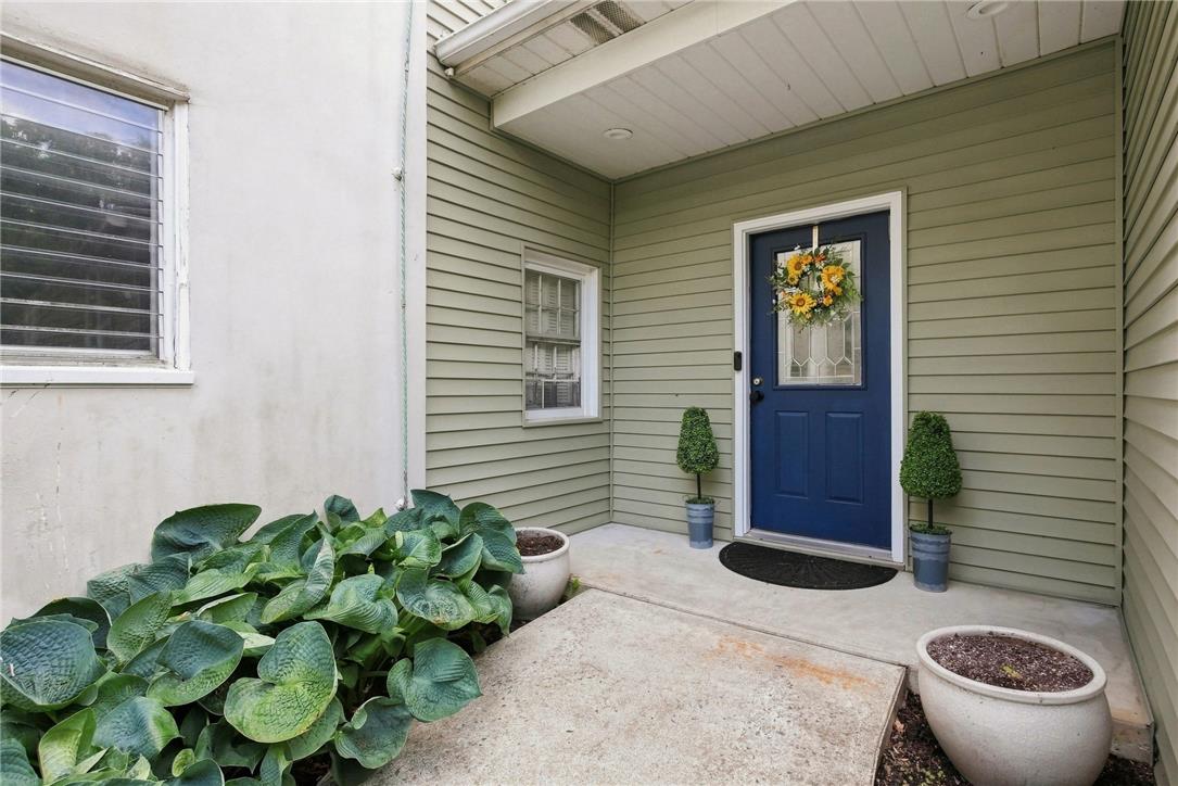 3408 Oak Hill Road Emmaus, PA 18049 - Photo 2 of 93 An inviting covered entryway welcomes with neat siding, concrete paving, and a paneled entry door.