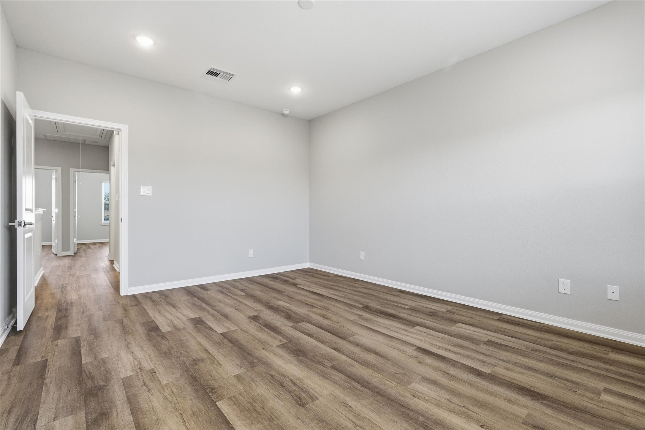 209 Clark Meadows Lane Houston, TX 77076 - Photo 15 of 50 a view of an empty room with wooden floor