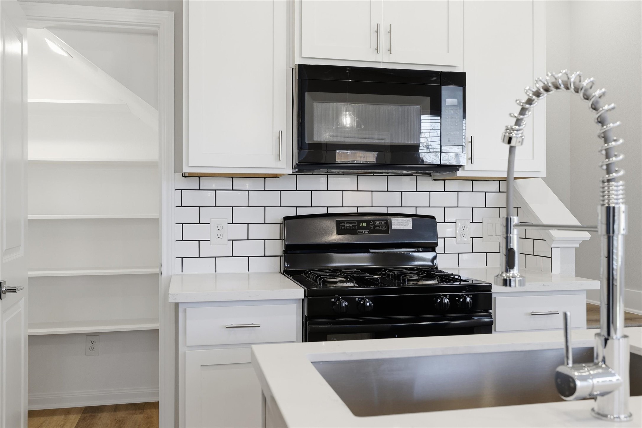 209 Clark Meadows Lane Houston, TX 77076 - Photo 3 of 50 a kitchen with stainless steel appliances a stove and a microwave