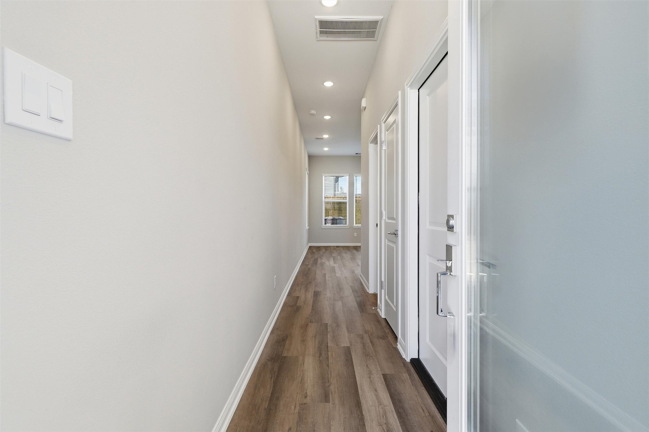 209 Clark Meadows Lane Houston, TX 77076 - Photo 39 of 50 a view of a hallway with wooden floor and staircase