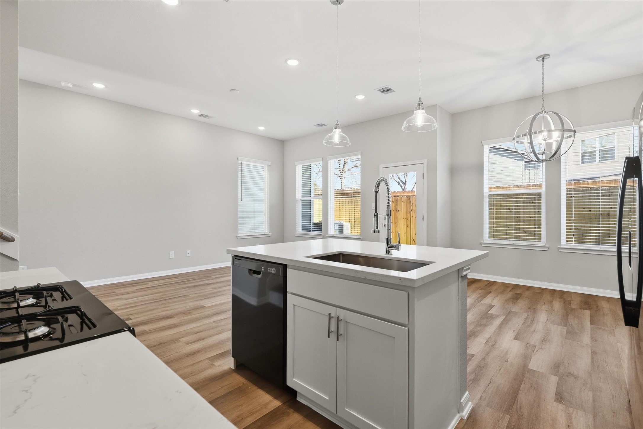209 Clark Meadows Lane Houston, TX 77076 - Photo 5 of 50 a kitchen with stainless steel appliances granite countertop a stove and a wooden floors