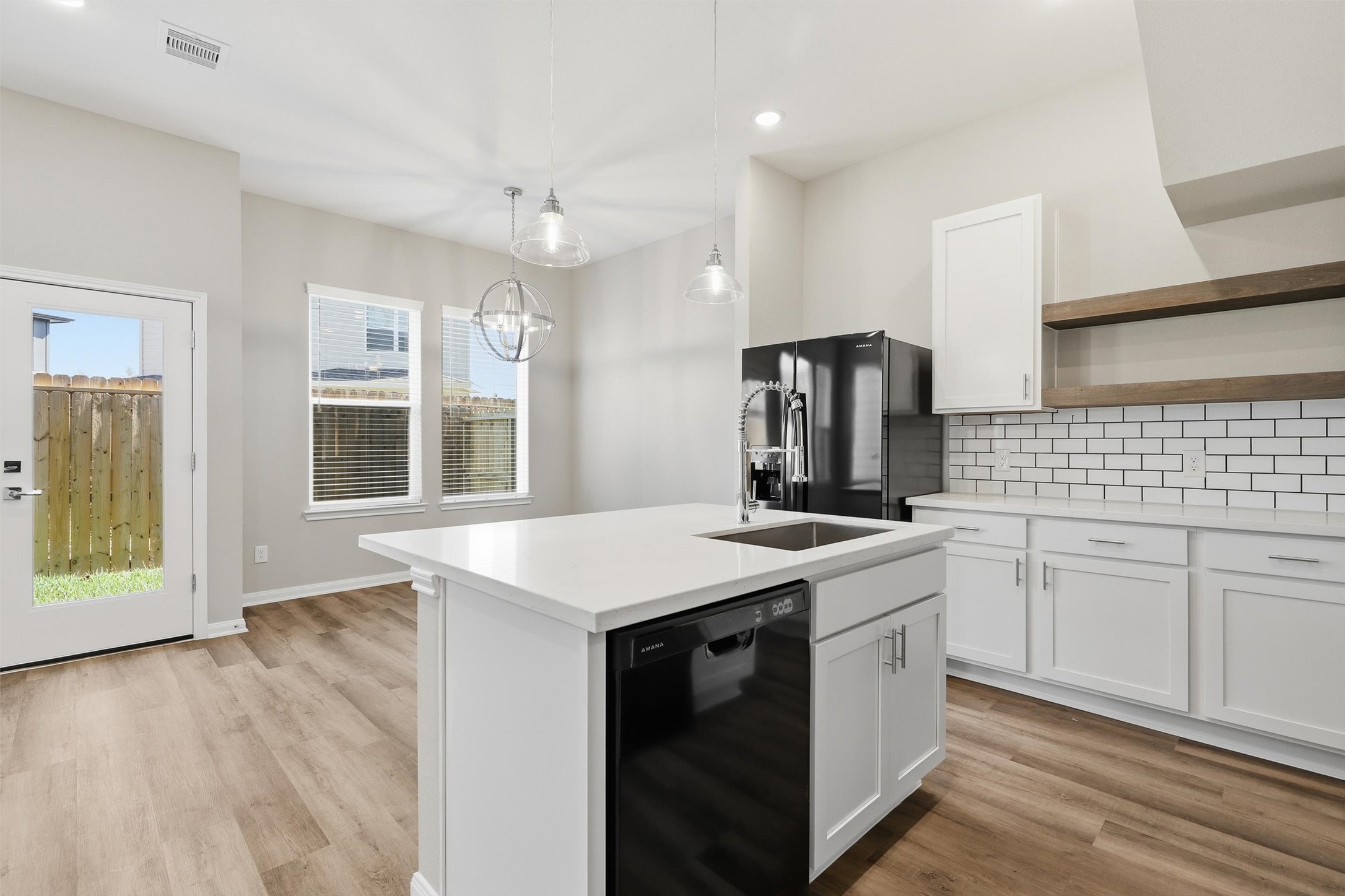 209 Clark Meadows Lane Houston, TX 77076 - Photo 8 of 50 a kitchen with a stove sink and refrigerator