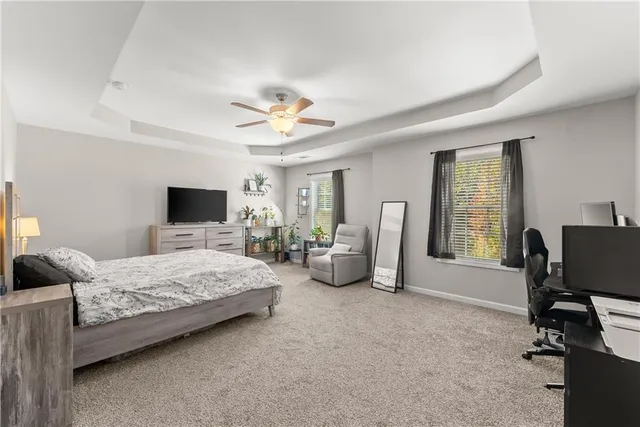 a bedroom with bed and a large window