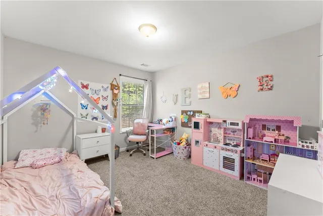 a bedroom with furniture and a large window