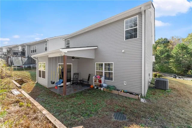 a view of a house with backyard sitting area and garden