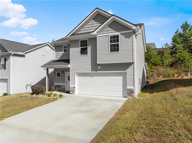 a front view of a house with garage