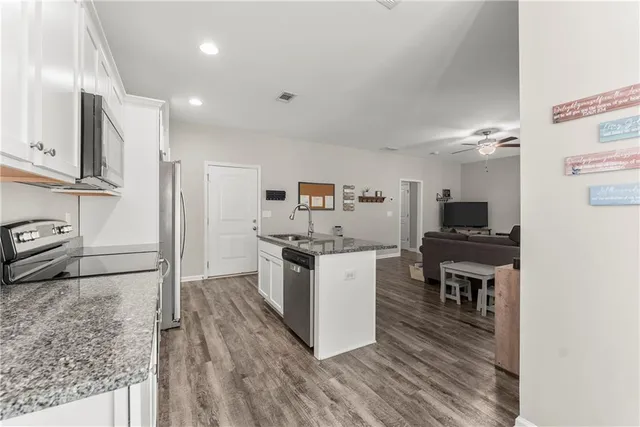 a kitchen with a refrigerator and a stove top oven