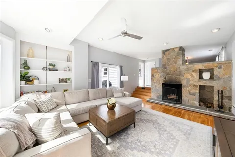 a living room with furniture and a fireplace