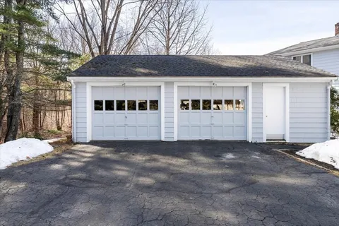 a view of a house with a yard and garage