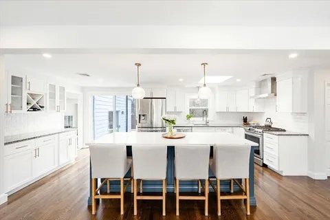 a large kitchen with a table and chairs