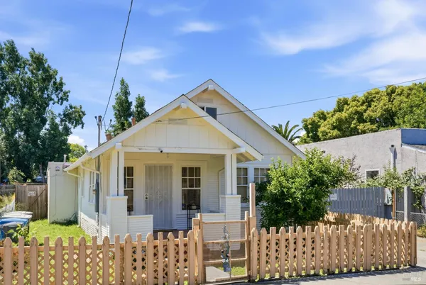 a view of a house with wooden fence