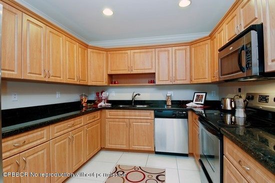 121 Gregory Road West Palm Beach, FL 33405 - Photo 3 of 8 a kitchen with stainless steel appliances granite countertop a stove sink microwave and cabinets