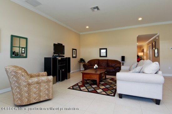 121 Gregory Road West Palm Beach, FL 33405 - Photo 4 of 8 a living room with furniture and a flat screen tv