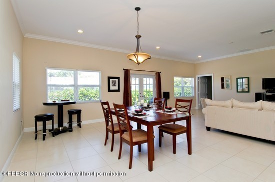 121 Gregory Road West Palm Beach, FL 33405 - Photo 5 of 8 a dining room with furniture a large window and a rug