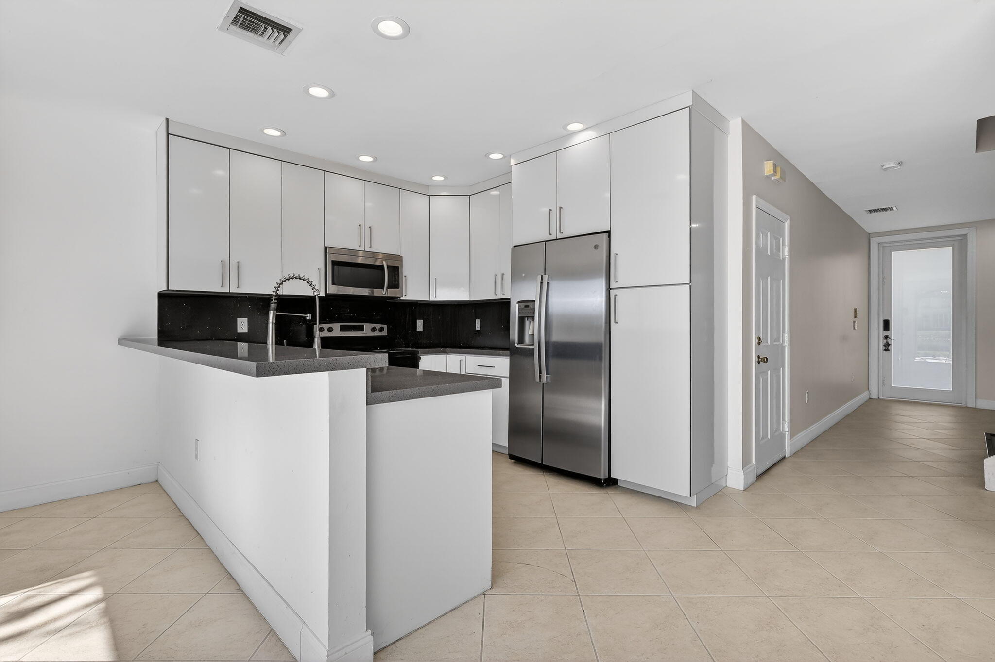 16286 Southwest 47th Manor Miramar, FL 33027 - Photo 11 of 61 a kitchen with stainless steel appliances granite countertop a refrigerator a stove a microwave and a refrigerator