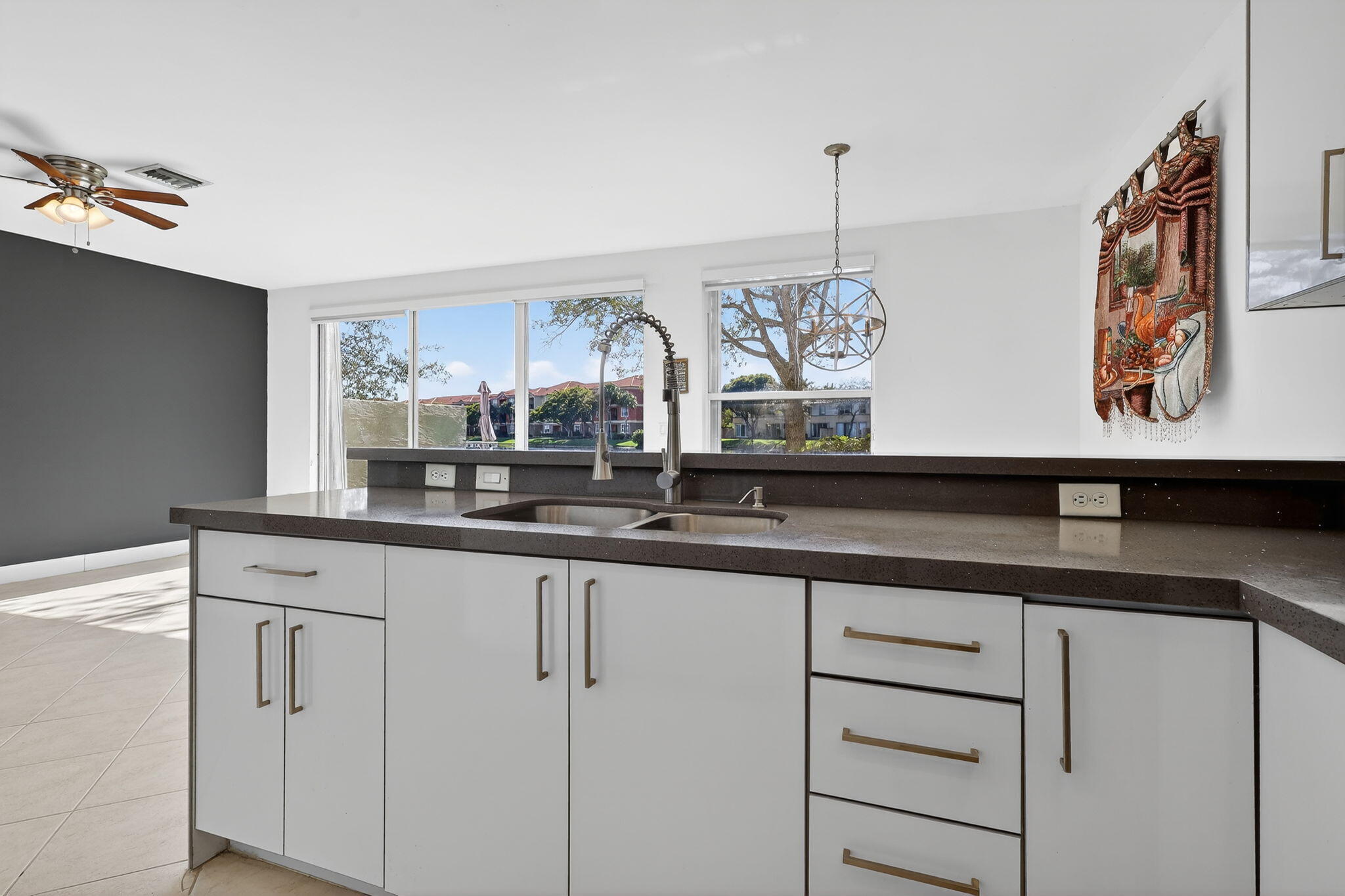 16286 Southwest 47th Manor Miramar, FL 33027 - Photo 14 of 61 a kitchen with granite countertop white cabinets and a sink