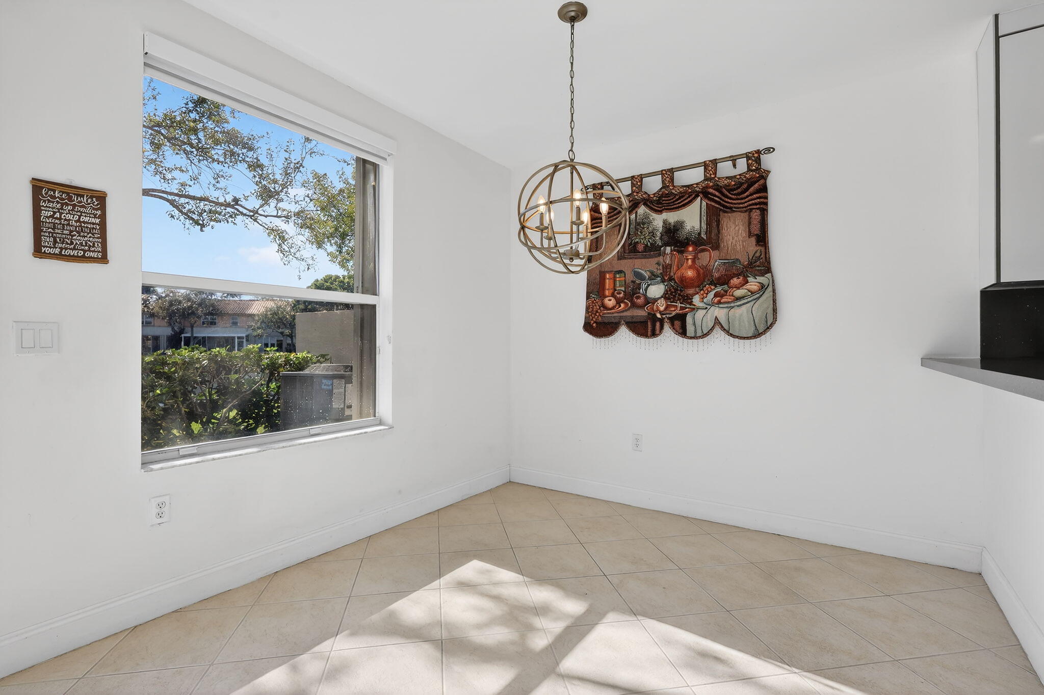16286 Southwest 47th Manor Miramar, FL 33027 - Photo 16 of 61 a view of a big room with a window and a chandelier