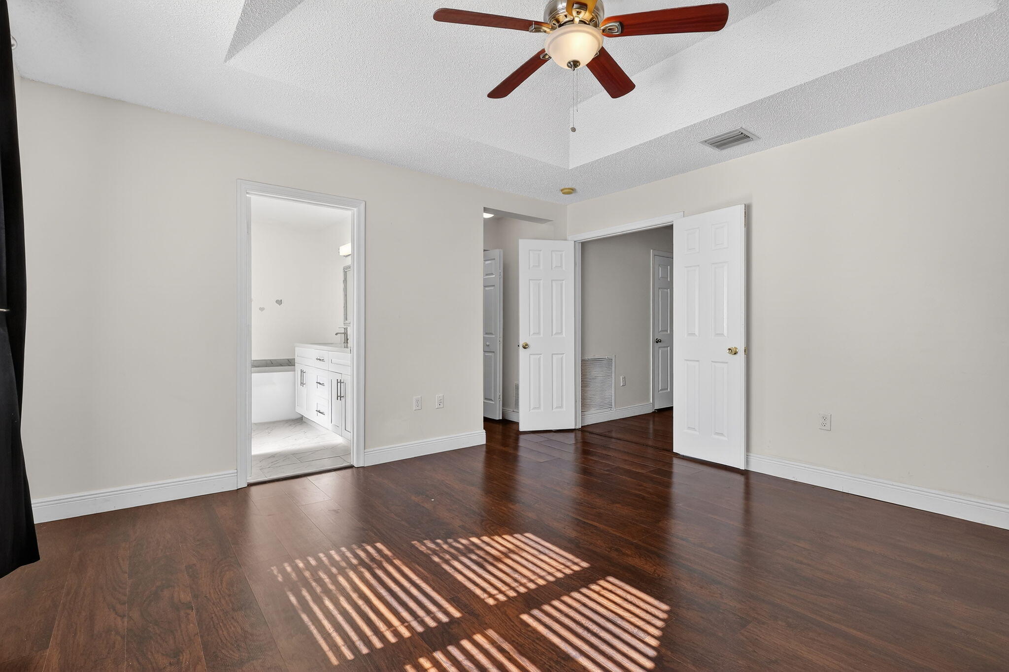 16286 Southwest 47th Manor Miramar, FL 33027 - Photo 24 of 61 a view of an empty room with wooden floor and a ceiling fan