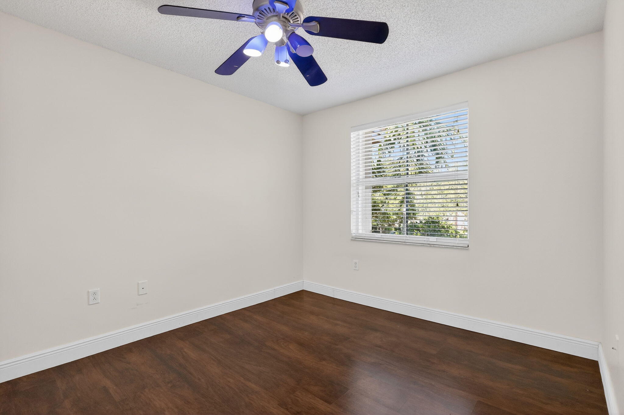 16286 Southwest 47th Manor Miramar, FL 33027 - Photo 33 of 61 an empty room with chandelier fan and windows