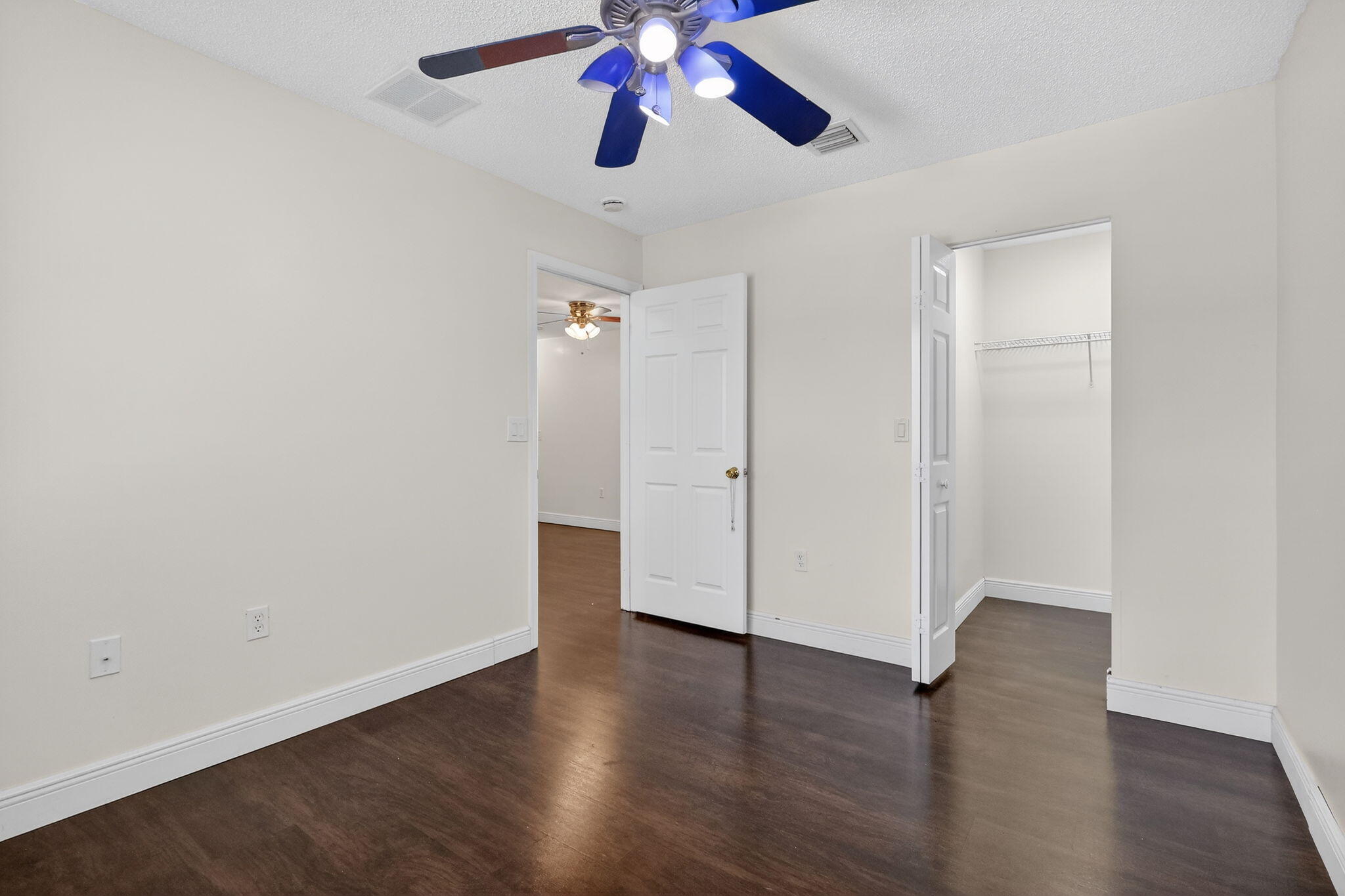 16286 Southwest 47th Manor Miramar, FL 33027 - Photo 34 of 61 an empty room with wooden floor a ceiling fan and closet