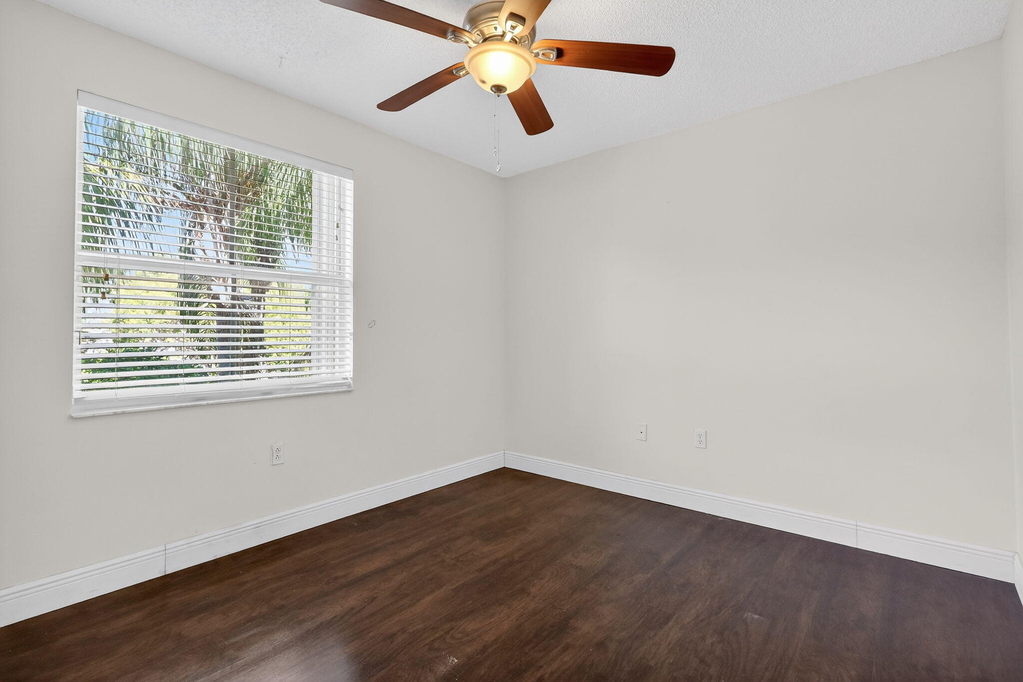 16286 Southwest 47th Manor Miramar, FL 33027 - Photo 39 of 61 a view of an empty room with wooden floor and a window