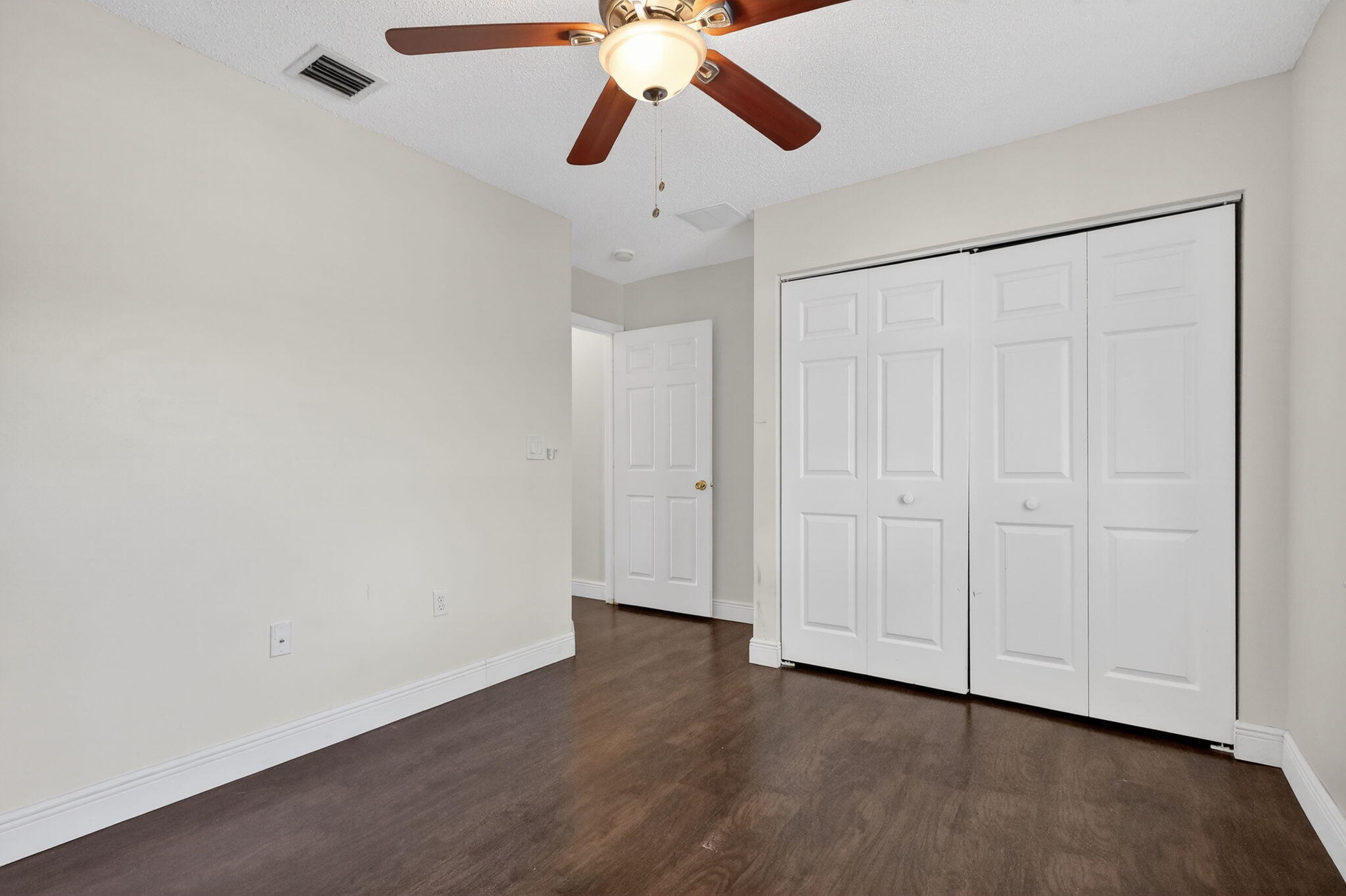 16286 Southwest 47th Manor Miramar, FL 33027 - Photo 40 of 61 a view of an empty room with a ceiling fan and window
