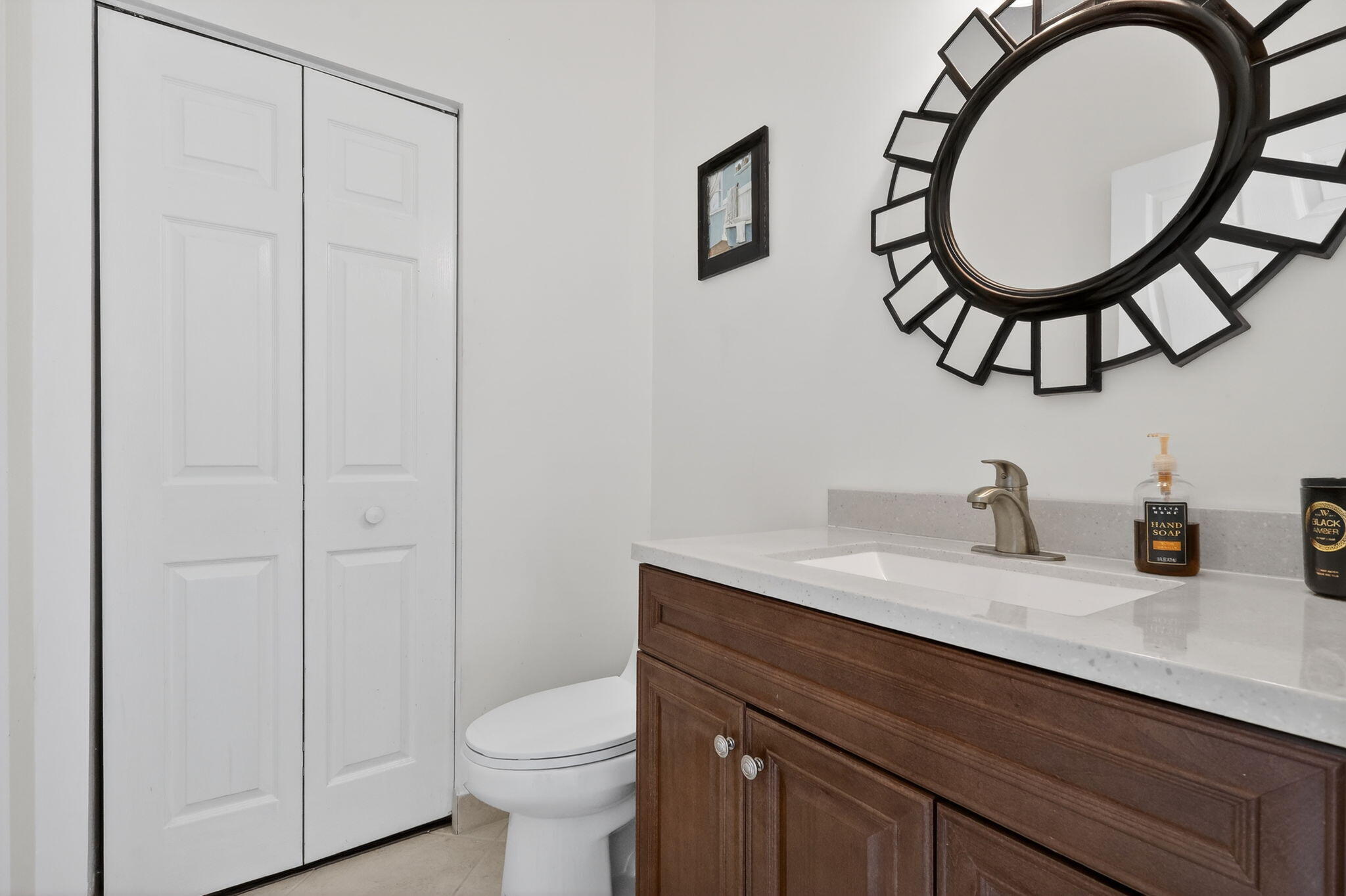16286 Southwest 47th Manor Miramar, FL 33027 - Photo 8 of 61 a bathroom with a toilet a sink and a mirror