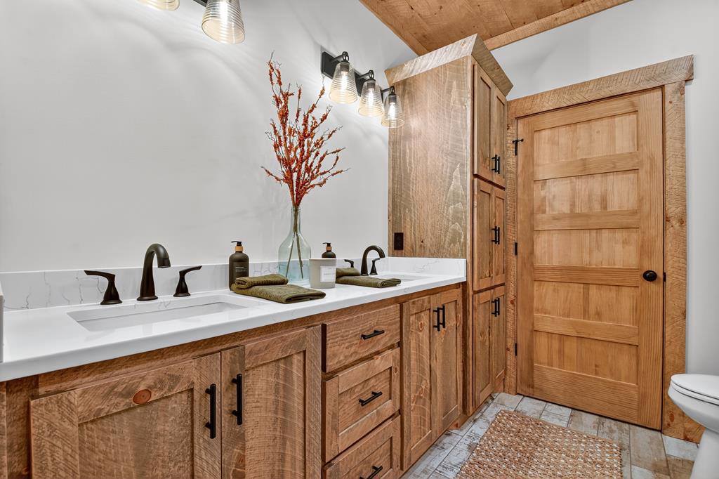 1204 Settler's Ridge Road Ellijay, GA 30540 - Photo 18 of 62 a bathroom with a double vanity sink and a mirror