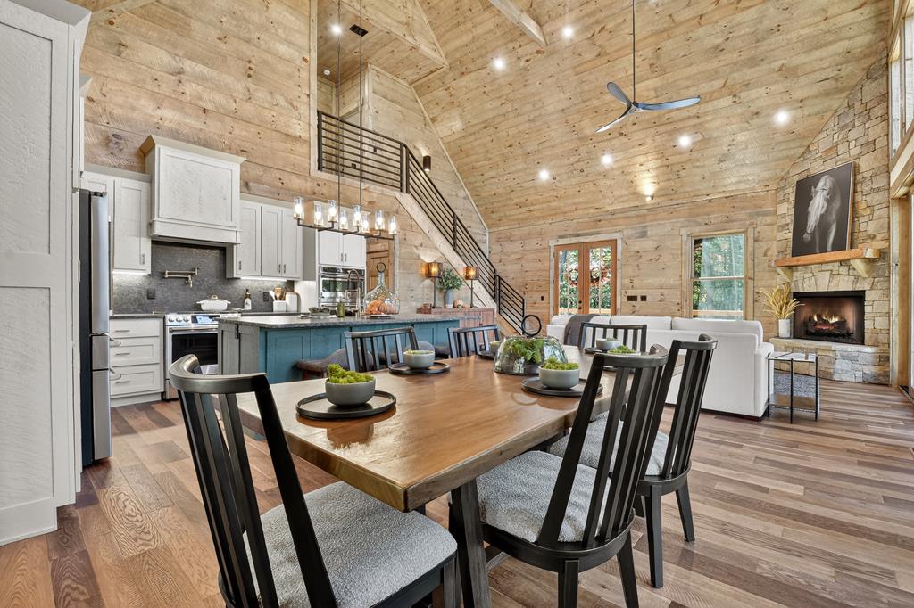 1204 Settler's Ridge Road Ellijay, GA 30540 - Photo 37 of 62 a view of a dining room with furniture and wooden floor