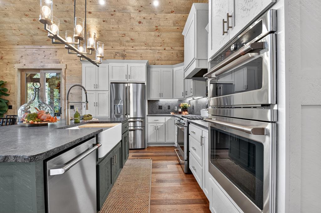 1204 Settler's Ridge Road Ellijay, GA 30540 - Photo 41 of 62 a kitchen with stainless steel appliances granite countertop a sink and a refrigerator