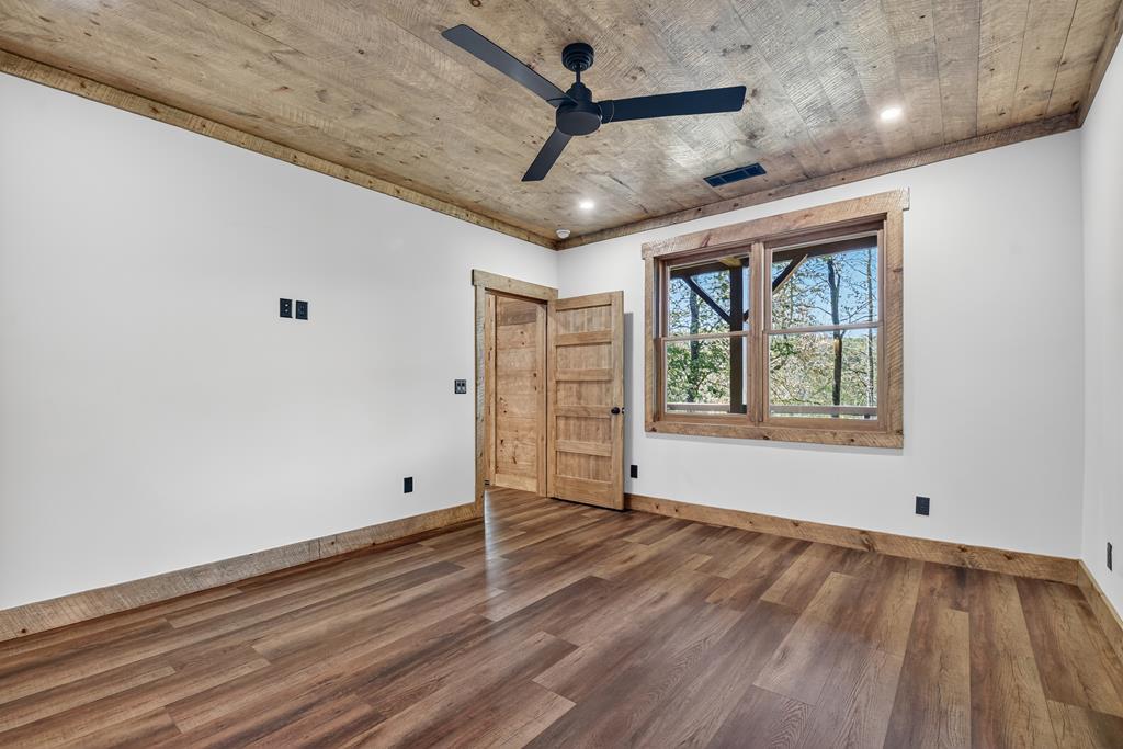 1204 Settler's Ridge Road Ellijay, GA 30540 - Photo 56 of 62 a view of an empty room with window and wooden floor