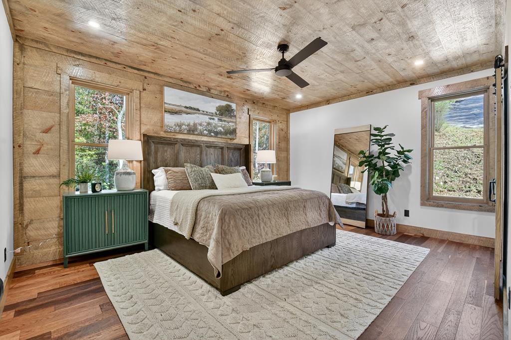 1204 Settler's Ridge Road Ellijay, GA 30540 - Photo 6 of 62 a bedroom with a large bed and a chandelier