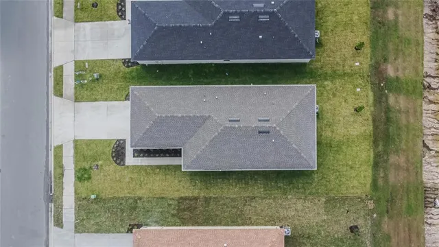 an aerial view of a residential apartment building with yard