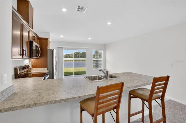a large kitchen with a large counter top appliances and cabinets